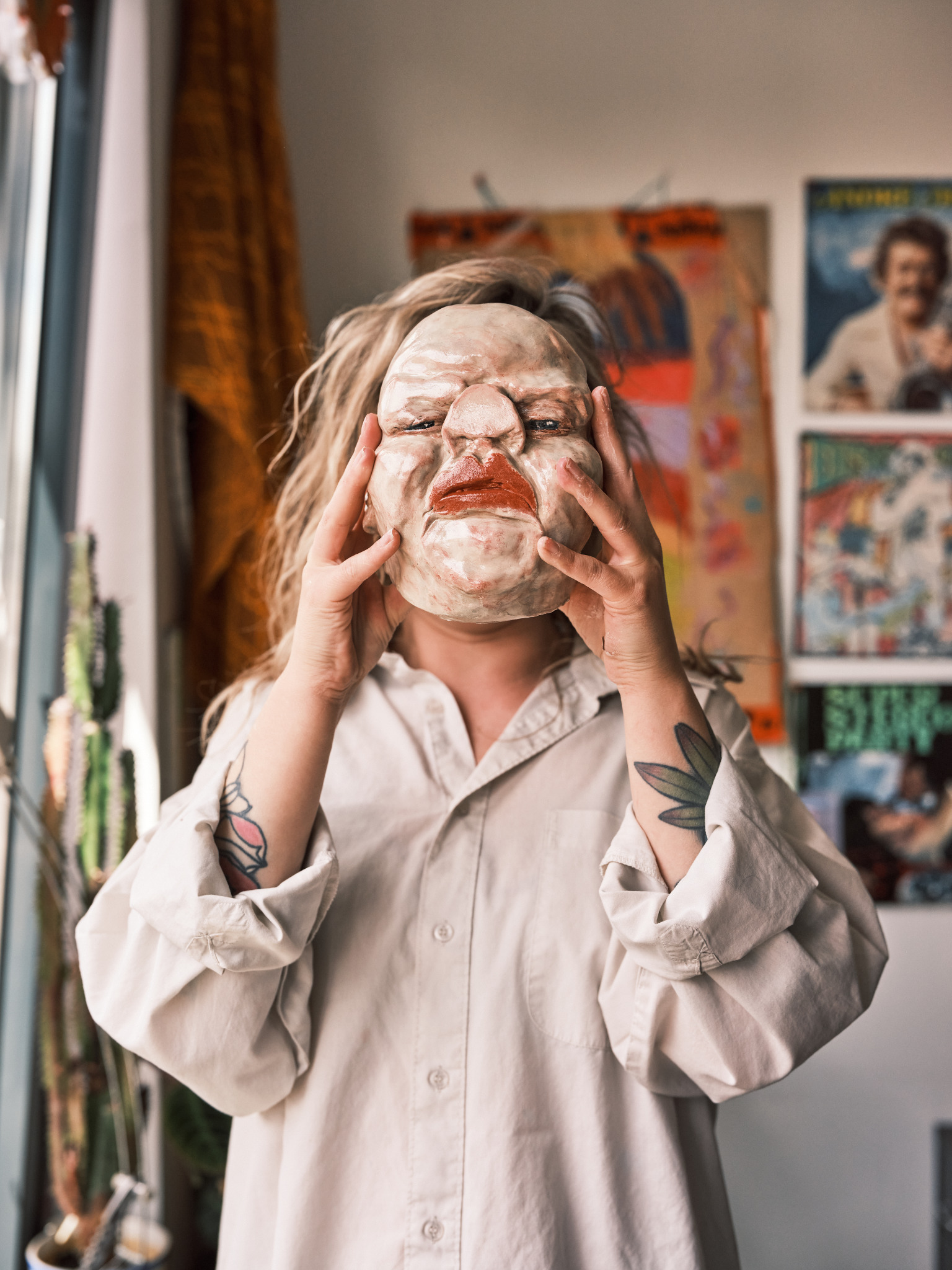 Ilse Donders holding one of her sculptures in her studio